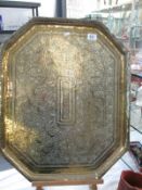 A large brass tray with Islamic design