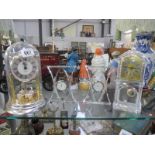 3 glass clocks and a clock under dome