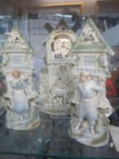 A Victorian pottery figural clock garniture