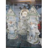 A Victorian pottery figural clock garniture