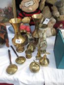 A collection of brass vases,