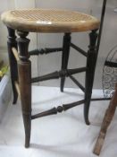 A cane topped stool