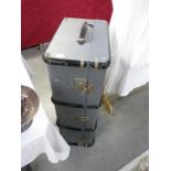 A large vintage grey travel suitcase