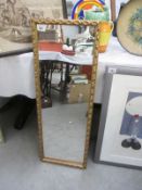 A gilt framed rectangular mirror