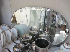 An oval wall mirror