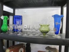 A shelf of glassware including early glasses