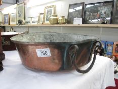 A large copper bowl with handle