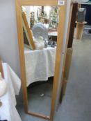 A large wooden framed rectangular mirror