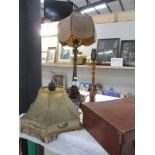 A c1940s wooden table lamp with plastic shade,