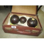 A set of bowls in vintage brown case