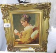 A retro gilt framed picture of a lady reading