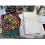 A quantity of linen and coloured material items