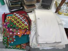 A quantity of linen and coloured material items