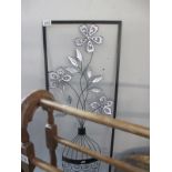 A metal picture of a flower in vase