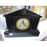 A heavy black slate clock