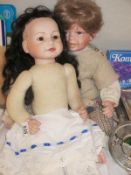 Two porcelain headed dolls - boy and girl