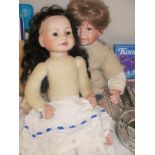 Two porcelain headed dolls - boy and girl