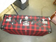 A red tartan suitcase