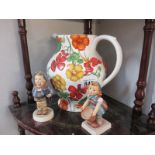 Two Hummel figures and a pottery water jug