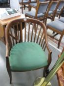 A slat back chair with upholstered seat