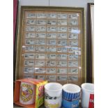 A framed and glazed cigarette card display featuring aviation