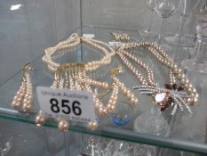 A collection of faux pearl jewellery items