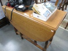 A large light oak gate leg table