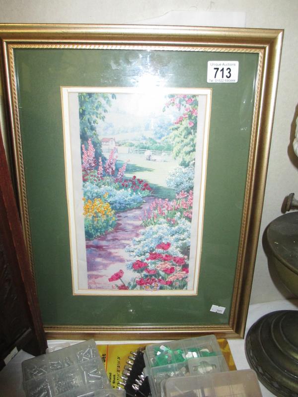A framed and glazed picture of a Garden Flower scene with added needlepoint flowers