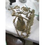 A wall hanging brass bell