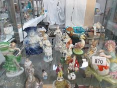 A collection of figurines including Victorian and Bunnykins