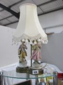 A figural table lamp with shade