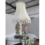 A figural table lamp with shade