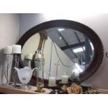 A wooden framed oval mirror