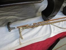 2 riding crops - one with silver handle inscribed L M Baines,