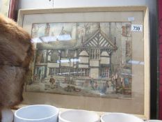 A framed and glazed picture of a Tudor style house and scene