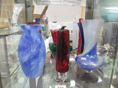 A collection ogf coloured vases etc