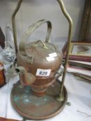 An old copper kettle on stand