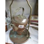 An old copper kettle on stand