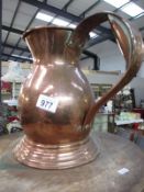 A copper jug with handle