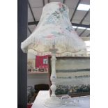 A white table lamp with floral shade