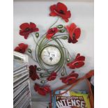 A wall clock with a Poppy floral surround