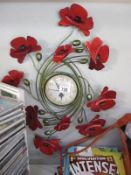 A wall clock with a Poppy floral surround