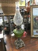 A Victorian oil lamp with cast base,