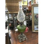 A Victorian oil lamp with cast base,