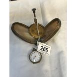 A pocket watch in mother of pearl stand