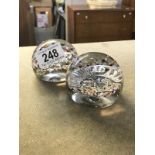 2 paperweights encapsulating military badges,