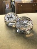 2 paperweights encapsulating military badges,