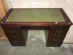 A darkwood stained office double pedestal desk with leather inset top