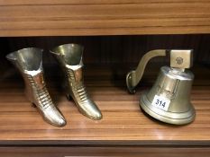 A brass bell and a pair of brass boots