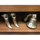 A brass bell and a pair of brass boots